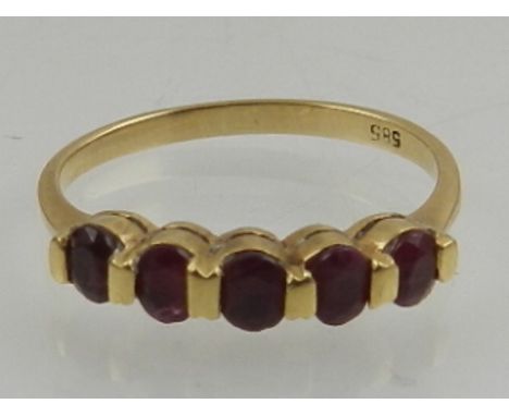 A 14 carat yellow gold and five stone ruby ring. 