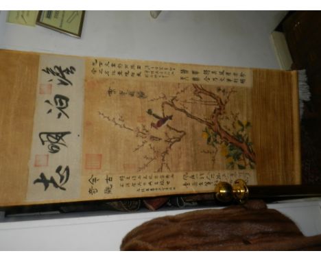 A Chinese scroll, depicting birds in a tree amongst foliage, bears character marks. 