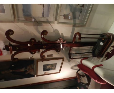 A Victorian mahogany hall stand, with eleven brass hooks terminating in ceramic balls, the base incorporating a stick/umbrell