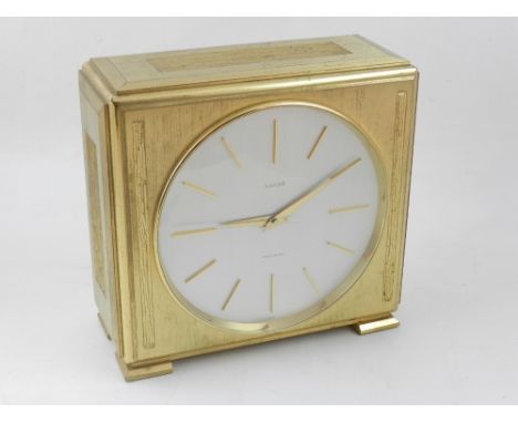 A Luxor gilt metal bracket clock, the silvered dial with baton markers, raised on bracket feet. H: 18cm
