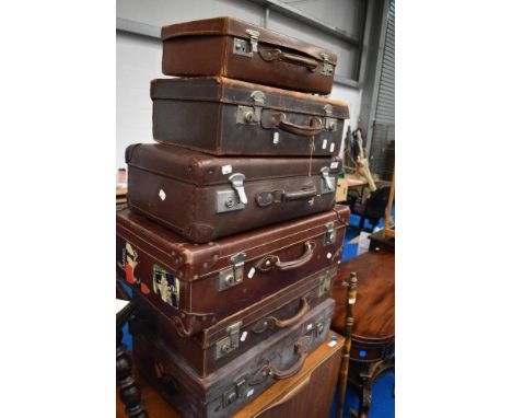 A selection of vintage luggage cases, including leather , some with travel labels