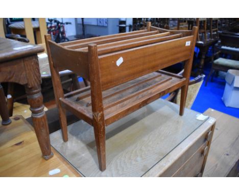 A vintage teak paper rack