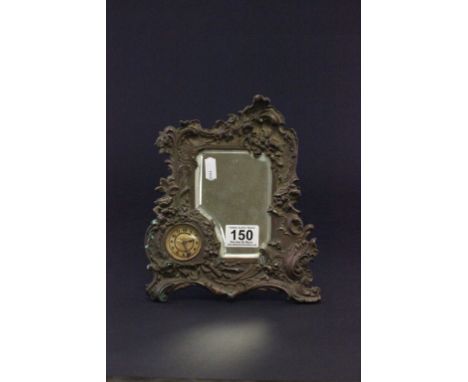 An early 20th century spelter framed mirror with an easel back , with small clock 