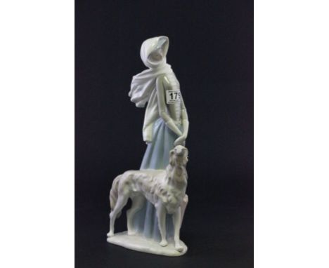 A Lladro figure of lady walking a dog 