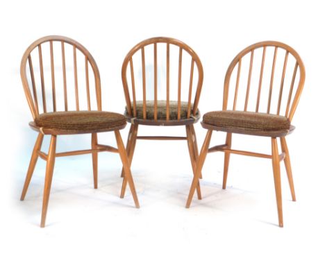 A set of three Ercol elm seated and beech framed spindle back dining chairs with loose cushions   CONDITION REPORT:  With hea