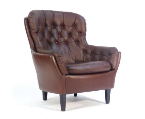 A 1960's brown leather and button upholstered tub armchair on mahogany square feetGood for age, some minor marks and wear