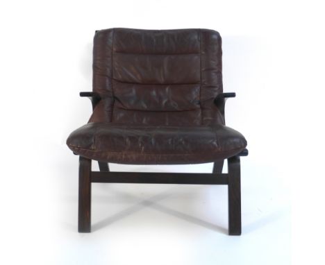 A 1970's brown button upholstered low-back armchair on a laminate frame   CONDITION REPORT:  Wear commensurate with age, some