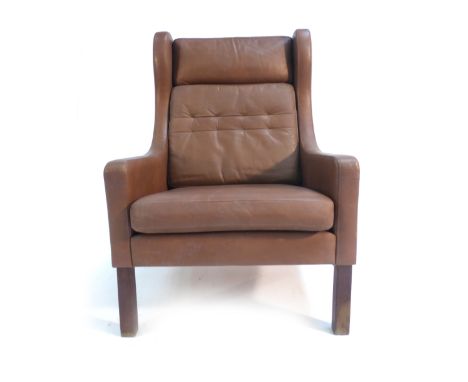 A 1970's brown and button upholstered wingback armchair on mahogany square straight legs   CONDITION REPORT:  Some wear, stru