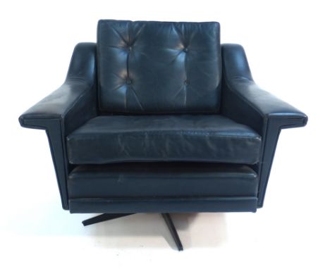 A 1970's black leather and button upholstered lounge armchair on a black five star swivel base   CONDITION REPORT:  Wear comm