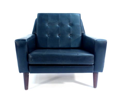 A Danish black vinyl and button upholstered lounge armchair on teak tapering legs