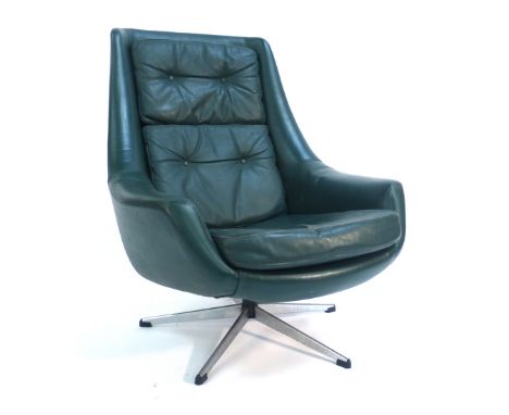 A 1970's green and button upholstered tub chair on an aluminium five star base   CONDITION REPORT:  Some cracking and wear