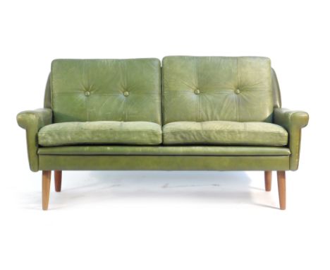 A Skippers Mobler green leather button upholstered two seater sofa on teak legs   CONDITION REPORT:  Heavy wear to seats and 