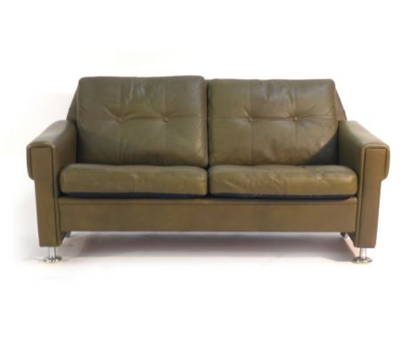 A 1980's Skippers Mobler green and button upholstered two seater sofa on chromed feet and castors   CONDITION REPORT:  Genera
