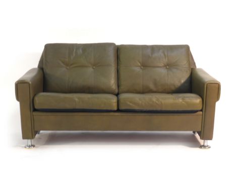 A 1980's Skippers Mobler green and button upholstered two seater sofa on chromed feet and castors   CONDITION REPORT:  Genera