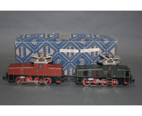 Two Marklin HO scale 0-8-0 electric locomotives, (3001 &amp; 3002), in dark red and dark green liveries, retaining a cardboar