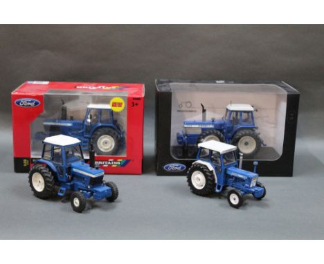 A group of two boxed and two unboxed diecast model tractors, to comprise a Britain's 1:32 scale Ford TW30 tractor, a Universa