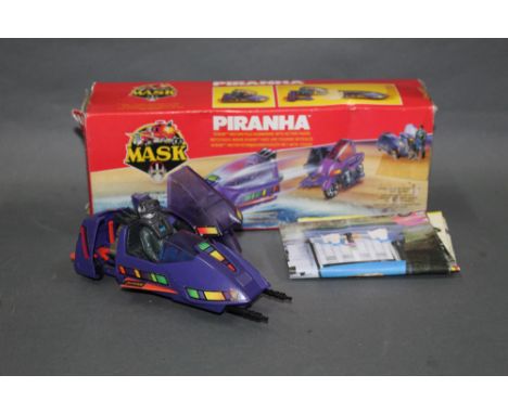 A 1980's Kenner Mask "Piranha", comprising a motorcycle/submarine with action figure, retaining its original cardboard and in