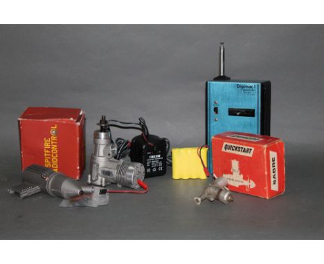 An assortment of mixed model airplane motors and accessories, including a Quick Start Sabre diesel engine box, a DC Limited e