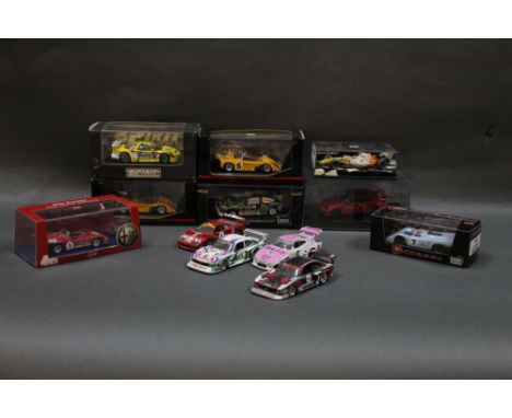 A group of boxed and unboxed scale model racing cars, by Brumm, Auto Art, Nikko, and Ixo