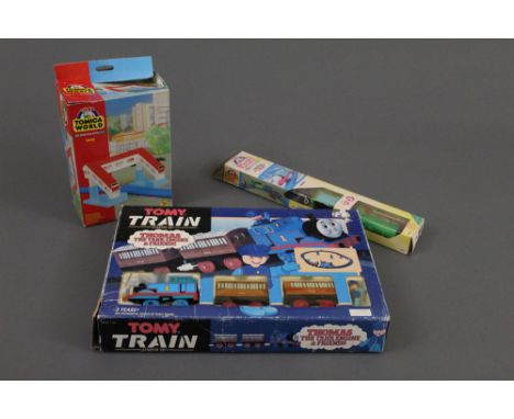 A Tomy "Thomas The Tank Engine &amp; Friends" train starter set, comprising engine, two passenger coaches, and track, a boxed