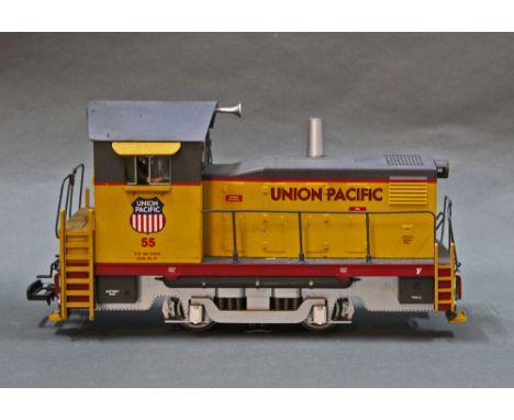 An Aristocraft G Scale Union Pacific locomotive, two coaches and level crossing 