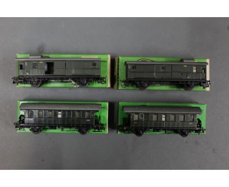 A group of four Marklin HO scale luggage wagons and passenger wagons, numbers comprising 4002 and 4041, all retaining their o