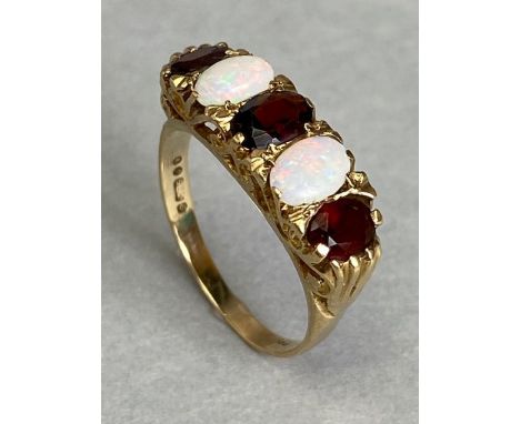 9ct Gold ring set with two Opals and three oval faceted red gemstones size approx 'P'