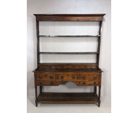 Antique Georgian dresser with five drawers, three planked shelf under, on turned legs, with set of fake drawers under a plate