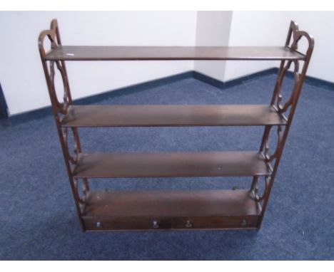 A mahogany wall shelf fitted with two drawers 