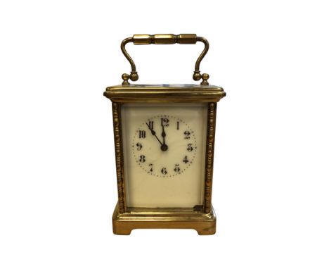 A brass cased French carriage clock, height 15cm including handle.  CONDITION REPORT: No key. Enamel dial with hairline crack
