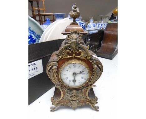 A Continental ormolu mounted mantel clock with enamel dial.