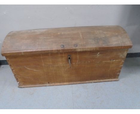 A 19th century oak dome topped shipping trunk with key.