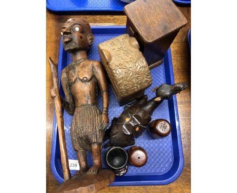 A tray containing a carved African tribal figure depicting a man with a walking stick, together with a leather camel ornament