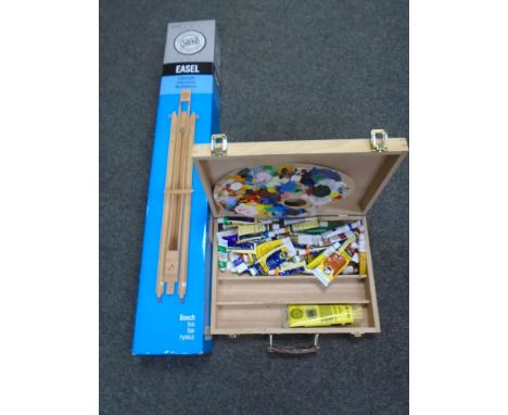 An artist's case containing paint, brushes and palette together with a boxed easel.