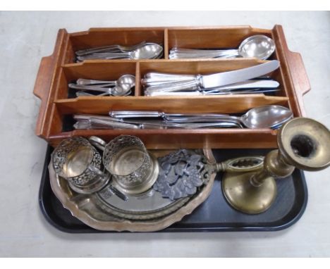 A tray containing a mahogany cutlery tray with plated cutlery, brass candlestick, hand mirror etc.