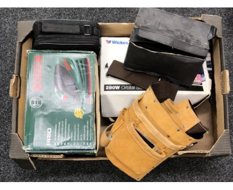 A box containing a leather tool belt, a Bosch sander, Wickes orbital sander etc.
