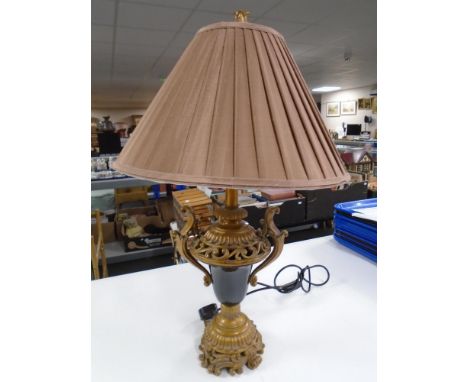 An ornate contemporary table lamp with shade.