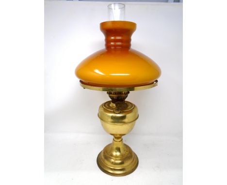 A 20th century brass oil lamp with glass shade.