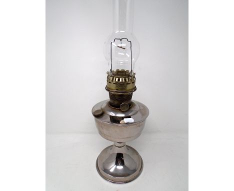 A 20th century chrome plated oil lamp with glass chimney.