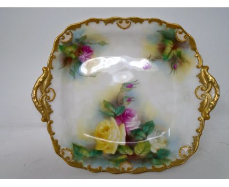A Royal Worcester gilded twin handled dish decorated with roses. (AF)