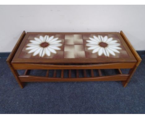 A 20th century teak tiled coffee table with under shelf 