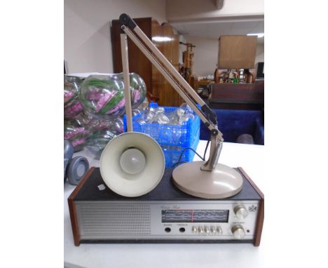 A Roberts radio together with an angle poise lamp.