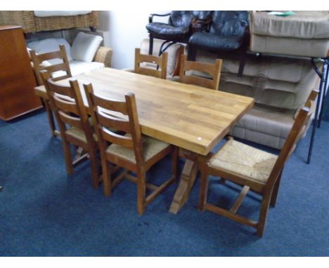 An oak farmhouse refectory kitchen table together with a set of six rush seated ladder back chairs. (7) 76 cm x 170 cm x 39 c