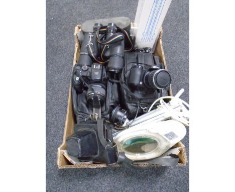 A box of cameras, pair of Prinz binoculars, magnifying lamp, Fujifilm camera etc 