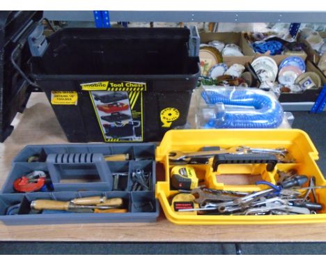 A mobile tool chest containing tools together with an air hose.