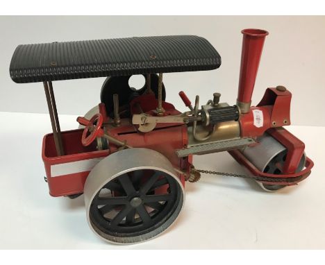 A Wilesco "Old Smoky" live steam engine with chain driven steering, red painted, 32 cm long x 19 cm high