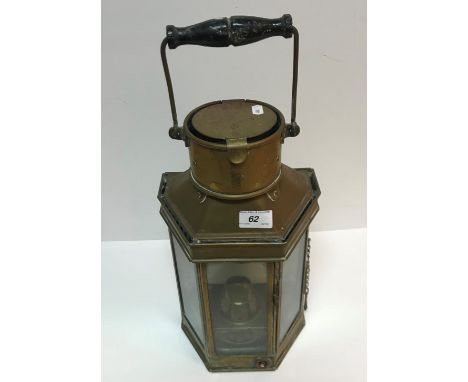A circa 1900 brass hexagonal signalling lamp with swing handle to the top and signalling handle to base, the main body with l