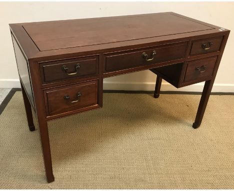 A Chinese dressing table, the plain top over one long and two pairs of short drawers on square tapered legs to scroll feet, 1