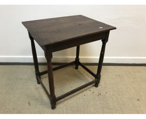 A 19th Century oak occasional table, the three plank top with cleated ends above a plain frieze on turned supports to blocks 