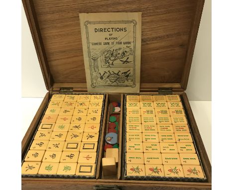 A carved teak cased Mahjong set together with Man Fung Cheung directions of playing Chinese game of four winds, box size 35 c